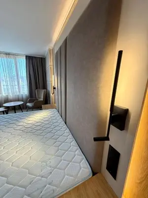 a bedroom with a large white bed in a room at Hotel Luxor in Burgas City