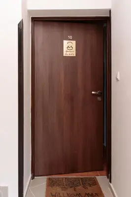 a wooden door with a sign on it at Apartment Sea Shell 1 in Sozopol