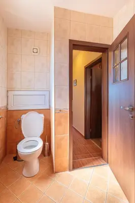 a bathroom with a white toilet in a room at Apartment Sea Shell 1 in Sozopol