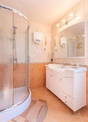 a bathroom with a white sink and a shower at Apartment Sea Shell 1 in Sozopol