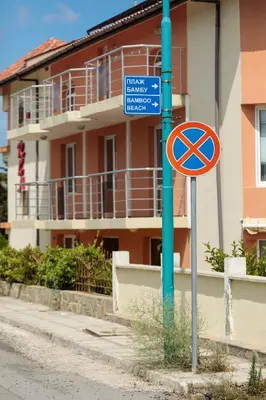 a street sign on a pole in front of a building at Apartment Sea Shell 1 in Sozopol