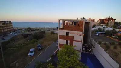 a building with a balcony on top of it next to the ocean at Design Hotel Logatero in Sozopol