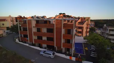 an apartment building with a car parked in front of it at Design Hotel Logatero in Sozopol