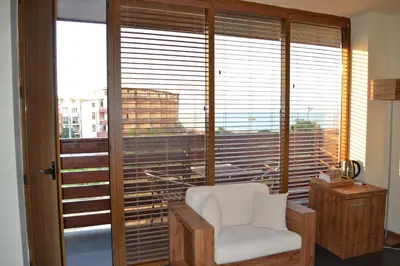 a room with a chair and a large window at Design Hotel Logatero in Sozopol