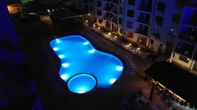 an overhead view of a swimming pool at night at Avalon Apartament in Sunny Beach