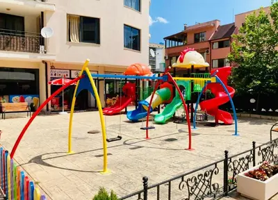a playground in front of a building at Avalon Apartament in Sunny Beach