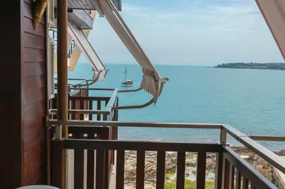 a balcony of a house with a view of the ocean at Fjord B&B in Sozopol