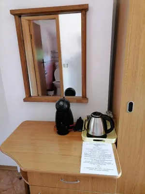 a tea kettle on a table with a mirror at Guesthouse Olimp in Sozopol