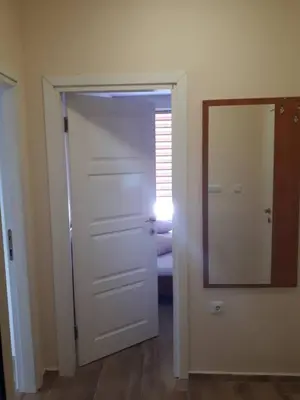 a door leading into a room with a mirror at CAPUCCINO GUEST APARTMENTS - FREE PARKING and Wi-Fi in Sunny Beach