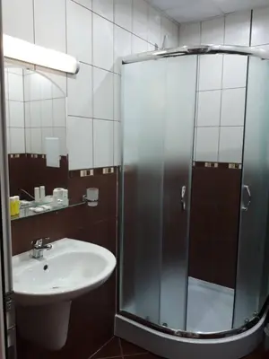a bathroom with a sink and a glass shower at CAPUCCINO GUEST APARTMENTS - FREE PARKING and Wi-Fi in Sunny Beach