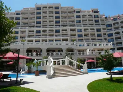 a large building with a swimming pool in front of it at Апартаменти Варна Саут на плажа - Varna South Apartments on the beach in Varna City