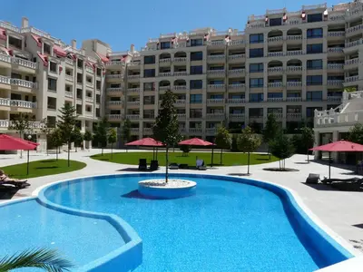 a swimming pool in front of a large building at Апартаменти Варна Саут на плажа - Varna South Apartments on the beach in Varna City