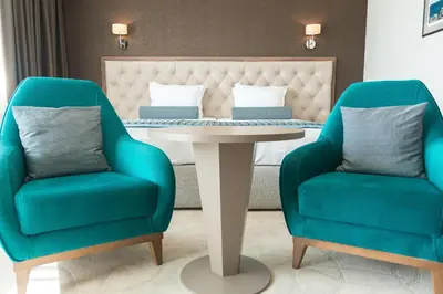 two chairs and a table with a table and two chairs at Hotel Cherno More in Varna City