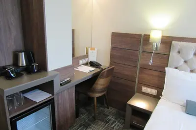 a hotel room with a desk and a bed at Hotel Cherno More in Varna City