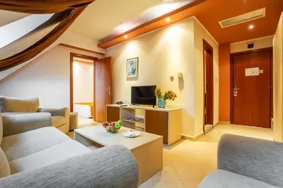 a living room with two couches and a tv at Family Hotel Gold Pearl in Sunny Beach