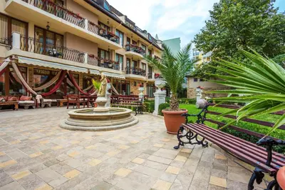 a courtyard with a fountain in front of a building at Family Hotel Gold Pearl in Sunny Beach