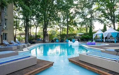 a large swimming pool with lounge chairs and a resort at Sunrise Hotel in Primorsko
