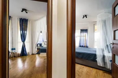 a room with a bedroom with a bed and a mirror at Sunrise Hotel in Primorsko
