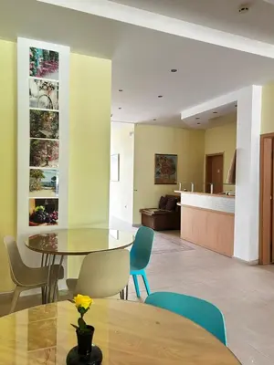 a dining room and living room with a table and chairs at Family Hotel Magnolia, Sunny Beach in Sunny Beach