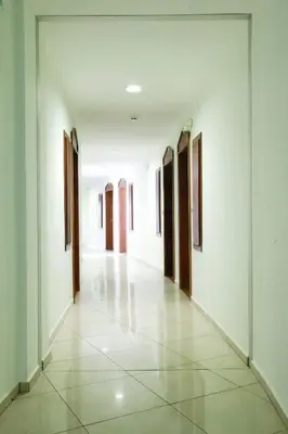 an empty corridor of a building with white walls at Hotel Caesars Palace in Sunny Beach