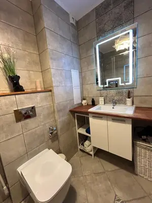 a bathroom with a toilet and a sink and a mirror at Edmond Apartment-Highspeed-Internet-Free! in Aheloy