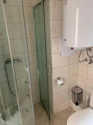 a bathroom with a glass shower with a toilet at Dawn Park Complex in Sunny Beach