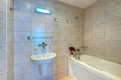 a bathroom with a sink and a bath tub at Dawn Park Complex in Sunny Beach