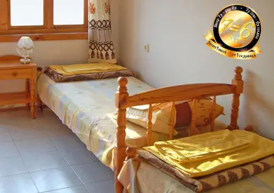 a bedroom with two twin beds and a window at Pension Dicev in Obzor