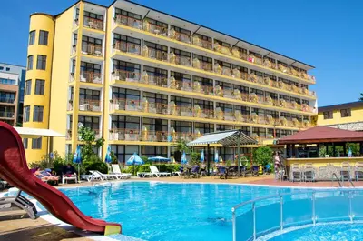 a swimming pool with a slide in front of a hotel at Hotel Trakia Garden in Sunny Beach