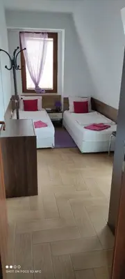 two beds in a room with a wooden floor at penyrent in Varna City