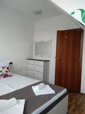 a bedroom with a bed and a dresser with a window at penyrent in Varna City