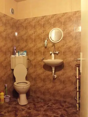 a bathroom with a toilet and a sink at Аria B&B in Burgas City