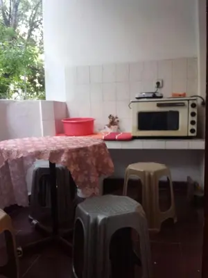 a kitchen with a table and a microwave at Аria B&B in Burgas City