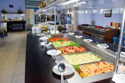 a buffet line with many different types of food at Sineva Park Hotel - All Inclusive in Sveti Vlas