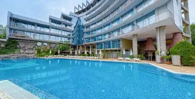 a large swimming pool in front of a building at Hotel Kamenec in Kiten