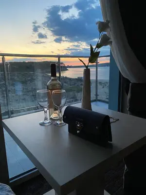 a table with a bottle of wine and two glasses at Hotel Kamenec in Kiten