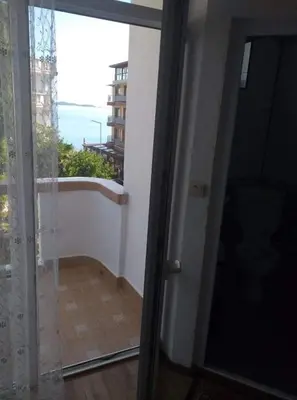 a door to a room with a view of a balcony at Primorsko Apartments in Primorsko