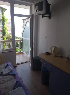 a living room with a door open to a balcony at Primorsko Apartments in Primorsko