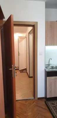 a hallway with a door open to a kitchen with a sink at Primorsko Apartments in Primorsko