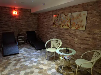 a living room with two chairs and a table at Family Hotel Teos in Kiten