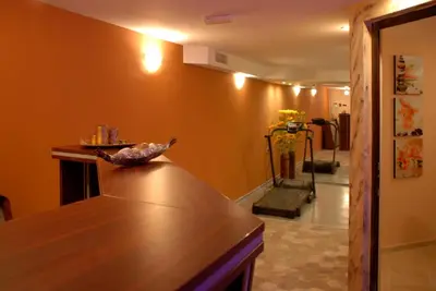 a kitchen with a counter with a bird sitting on it at Family Hotel Teos in Kiten