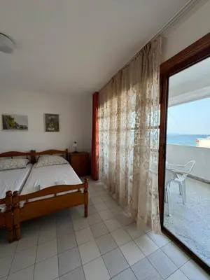 a bedroom with a bed and a view of the ocean at obzor, orkinos in Obzor