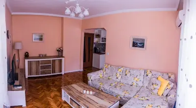 a living room with a couch and a table at Two Bedroom Apartment Downtown Ivanovi in Varna City