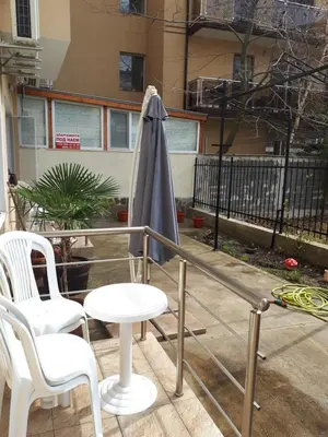 a patio with a table and chairs and an umbrella at Flowers Studio in Pomorie