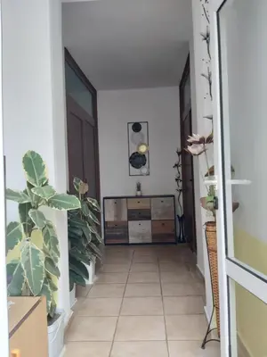 a hallway with a dresser and plants in a room at Kyshta za Gosti Dari Rumi 1 in Sozopol