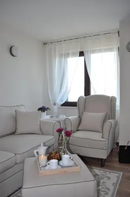 a living room with a white couch and a table at Villa Elea in Nesebar
