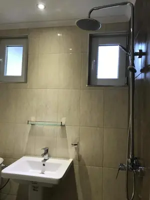 a bathroom with a sink and a shower at Villa Izgrev 24а in Chernomorets
