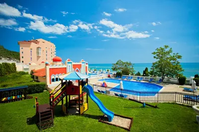 a playground with a slide next to a swimming pool at Royal Bay Hotel - All Inclusive in Elenite