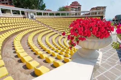 a vase with red flowers in it sitting in a stadium at Royal Bay Hotel - All Inclusive in Elenite