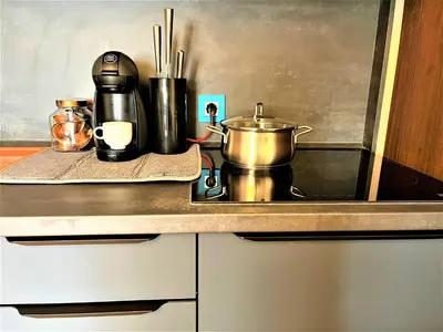 a kitchen counter with a stove with a pot on it at Bravo 5 Holiday Home in Sunny Beach